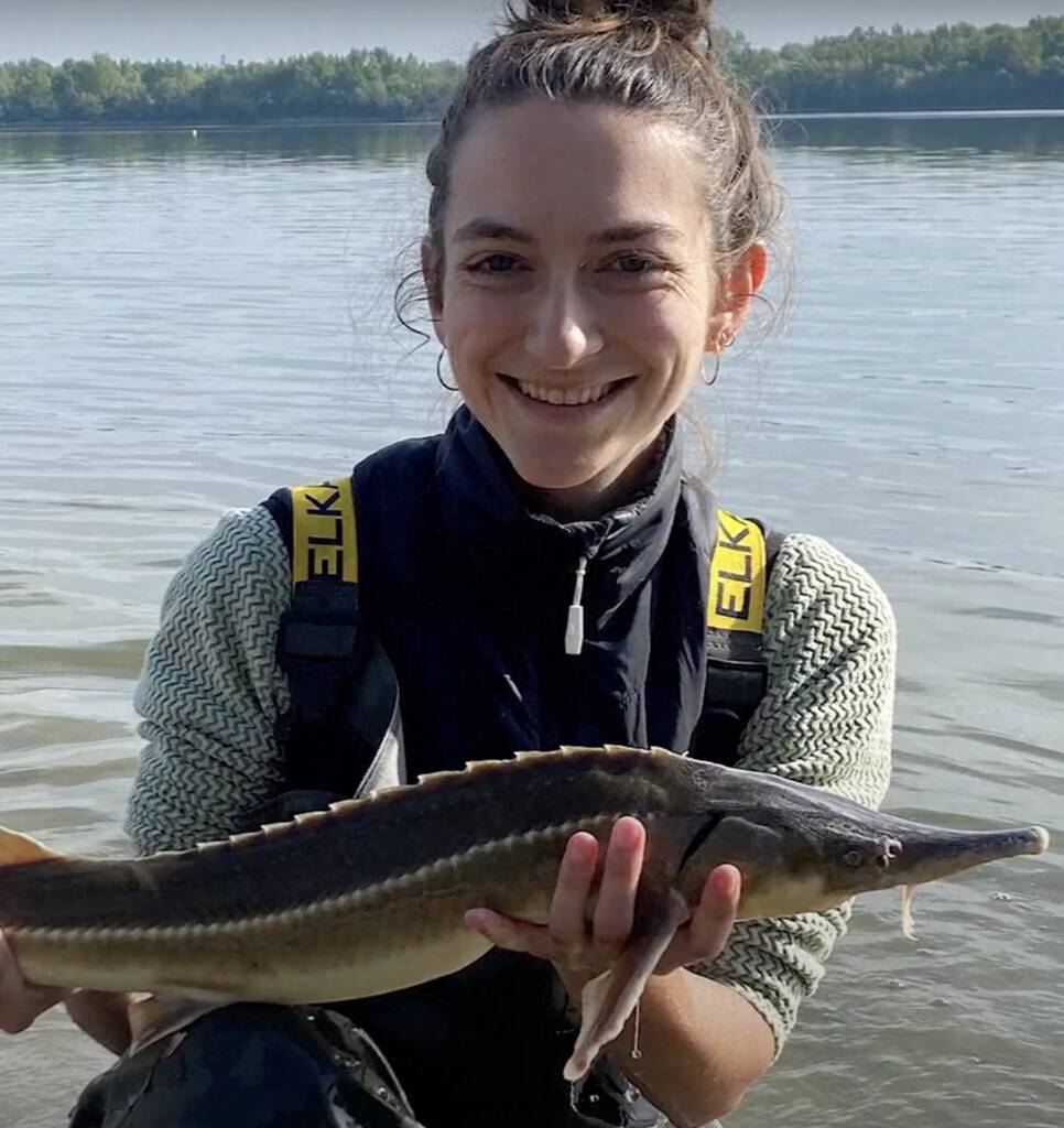 Video Screenshot with Biologist holding a sturgeon
